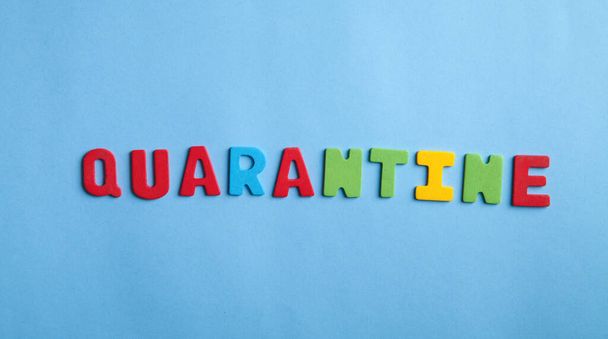 Colorful word Quarantine on the blue background. - Zdjęcie, obraz