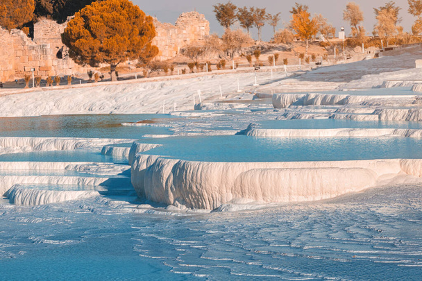 Famous travertines in the Turkish resort of Pamukkale near the city of Denizli. White mineral rock outcrops and thermal water sources. Wonder of nature - Photo, Image