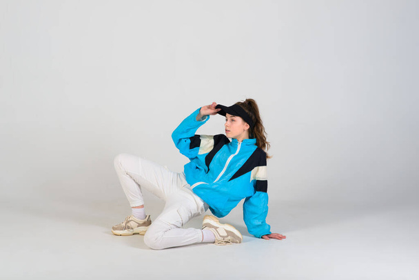 Teenage female dancing hip-hop in a studio, casual clothes - Фото, изображение