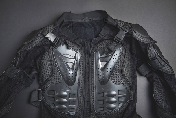 Black jacket on the black background. Motorbike safety clothing - Fotó, kép
