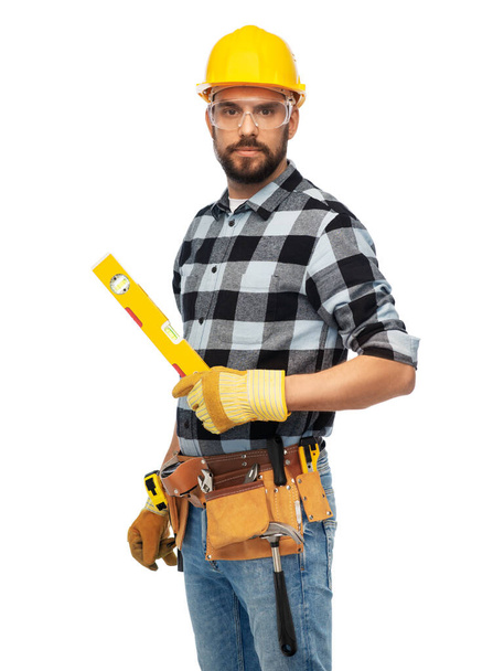 male worker or builder in helmet with level - Фото, изображение