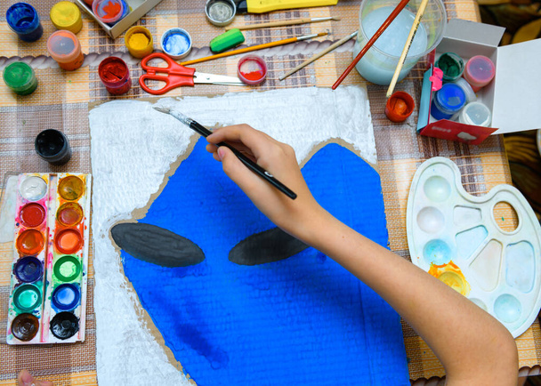 a girl drawing blue gouache cardboard, artistic creation at home, makes creative artwork - Photo, Image