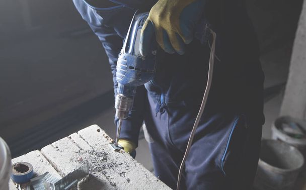 Master drills a hole in a metal. Industry - Zdjęcie, obraz