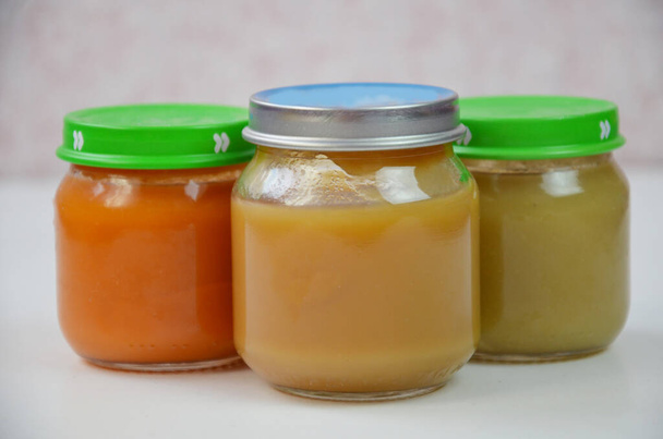 Three jars of baby food on white. - Valokuva, kuva