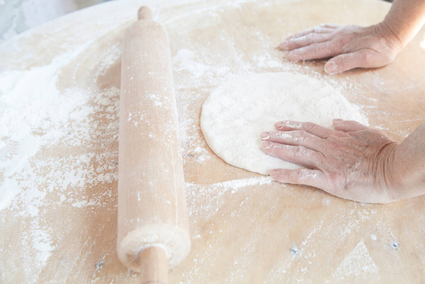 Woman preparing armenian bread lavash. - Foto, immagini