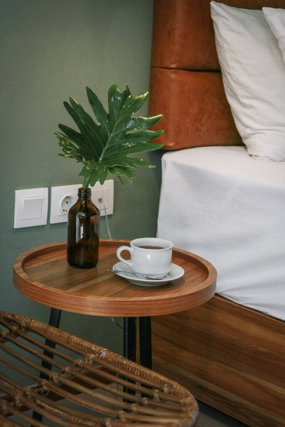 White pillows, duvet and duvet case on a bed and bedside table - Foto, Imagem