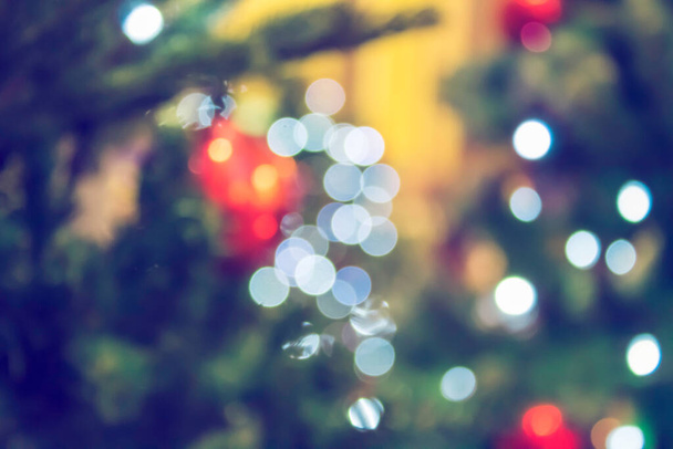 Christmas tree with decorations and lights, blurred abstract holiday new year background. - Foto, imagen