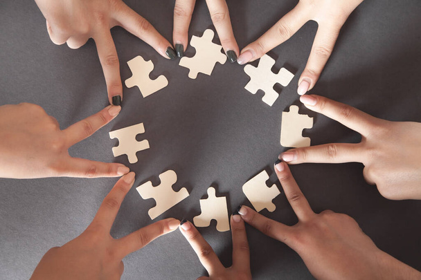 Hands of people with jigsaw puzzle. Partnership, Success, Teamwork - Photo, Image