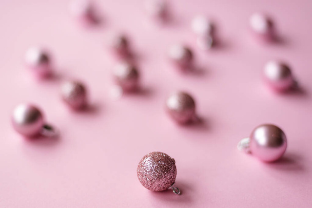 Pink Christmas tree toys, close up. Festive New Year layout, blurred background. - 写真・画像