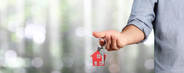 Agent nieruchomości przekazujący klucze do domu w ręce - Zdjęcie, obraz