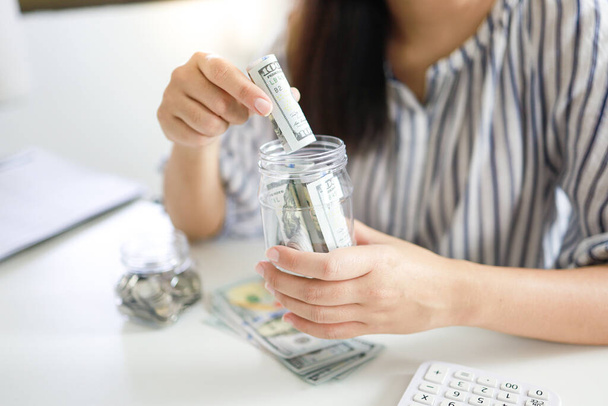 Εξοικονόμηση χρημάτων έννοια Οικονομική γυναίκα χέρι στοίβα κέρματα χρήματα χρήματα αυξάνεται επιχείρηση. μετρητά σε τραπεζογραμμάτια σε δολάρια - Φωτογραφία, εικόνα