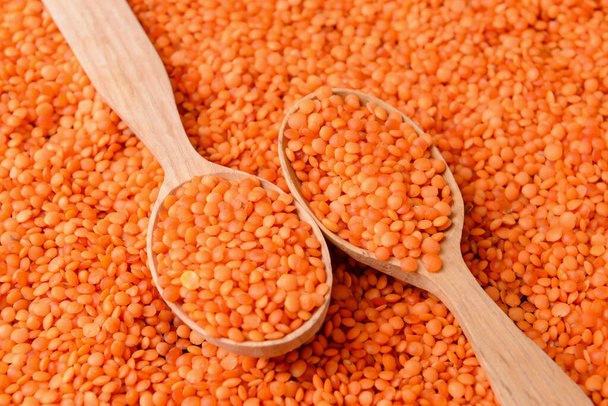 Wooden spoons on red lentils - Photo, Image