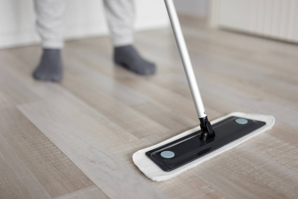 close up of man washing floor with mop at home - Photo, Image