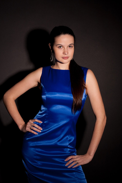 Part of woman in blue dress - Фото, изображение