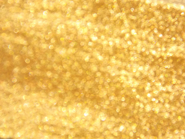 Abstract glanzend goud glitter bokeh achtergrond - Foto, afbeelding
