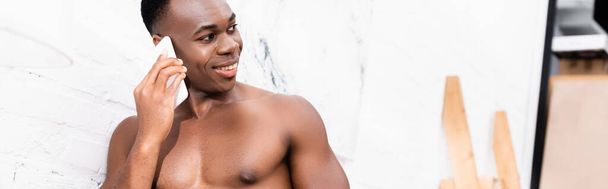 Shirtless african american man talking on cellphone at home, banner  - Photo, Image