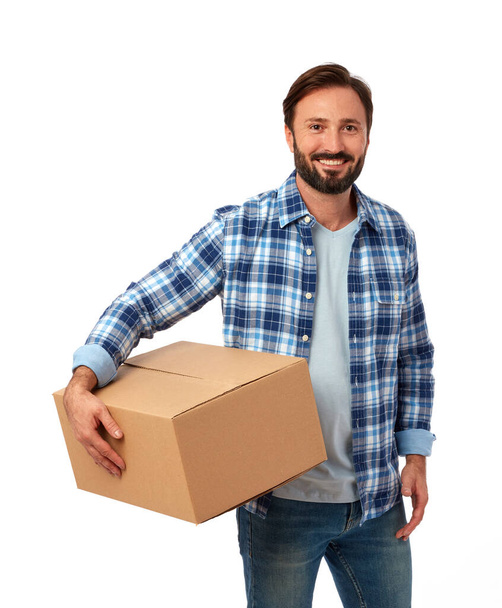 Delivery guy with cardboard box on white background - Photo, Image