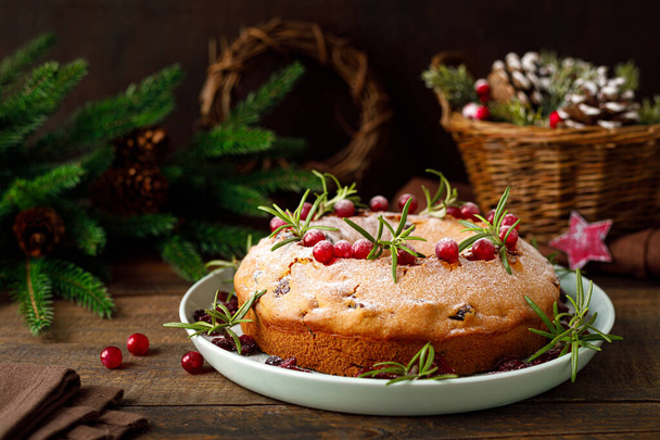 Christmas cranberry fruit cake with decorations on wooden background - Foto, Imagen
