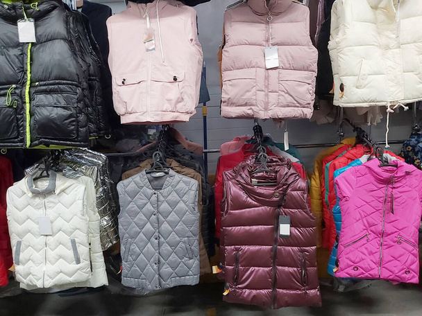 warm women's sleeveless jackets in the store. - Photo, Image