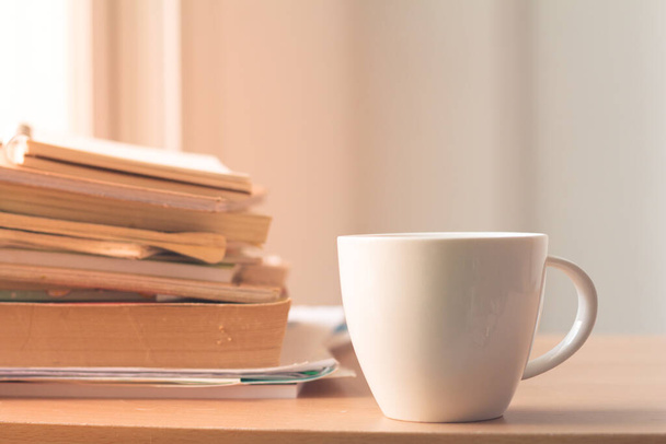 Cup of coffee with stack document on table.Busy office. - Foto, Imagen