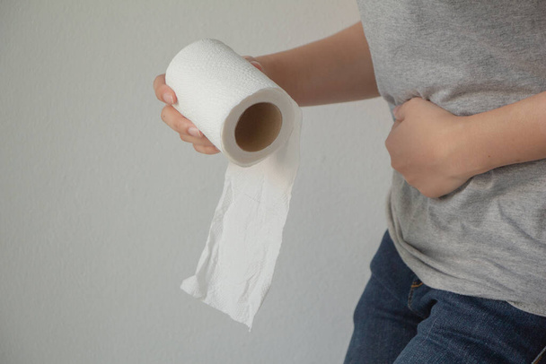 Women holding tissues paper and abdominal pain.Health care concept female need to use the bathroom. - Photo, Image