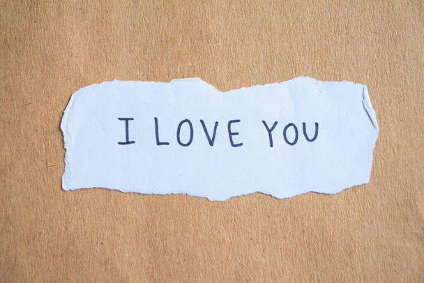 text I love you on brown paper. - Photo, image