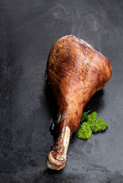 Roasted  turkey leg on black stone background  - Foto, Imagem