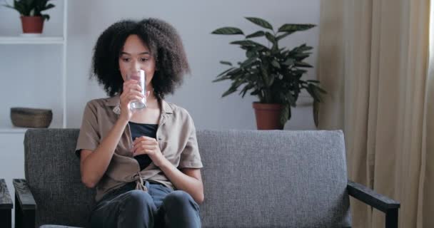 https://cdn.create.vista.com/api/media/small/426702786/stock-video-beautiful-mixed-race-teenage-girl-sits-relaxing-on-couch-in-apartment-after-hard-day-freshens?videoStaticPreview=true&token=