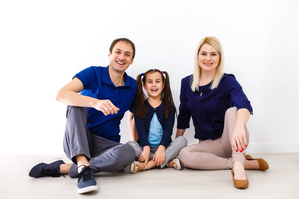 Happy to be a family. Happy family smiling while sitting indoors - Valokuva, kuva