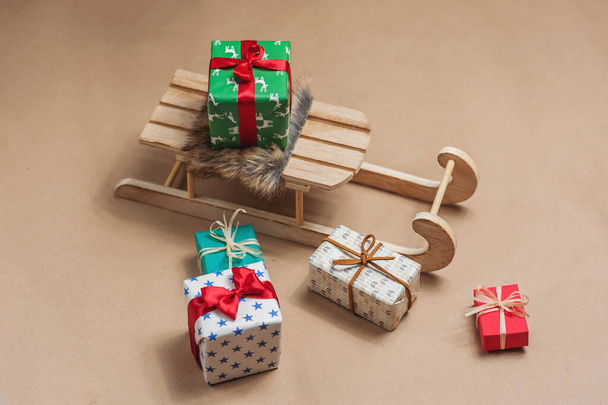 Sled with gifts on craft paper background. - Photo, image