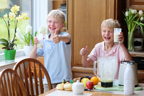 Teenager boys drinking cocktail from milk and fruits - Photo, Image
