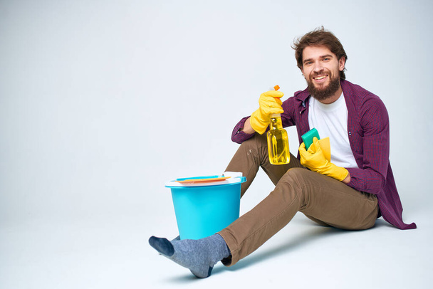 Cleaner with a bucket on the floor professional detergent service - Photo, image