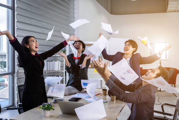 Successful happy workers Group of asian business people with diverse genders (LGBT) threw up the business plan in document paper into the air in the meeting room at office,emotionally satisfied with - Fotoğraf, Görsel
