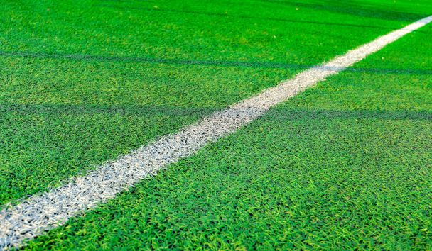 White stripe on green grass, on the football field. Football field with markings - Photo, Image