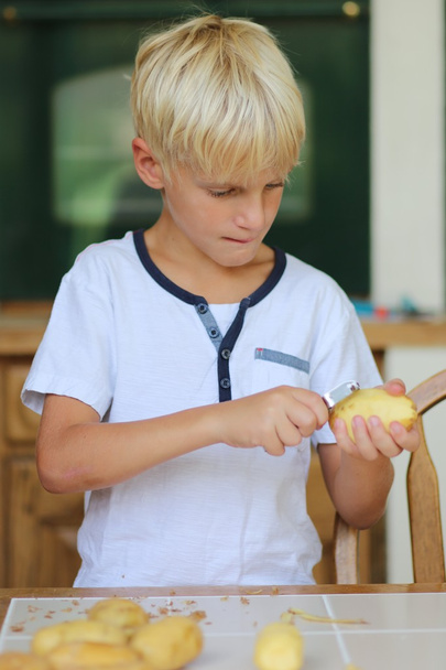 Boy peeling potatoes - Photo, Image