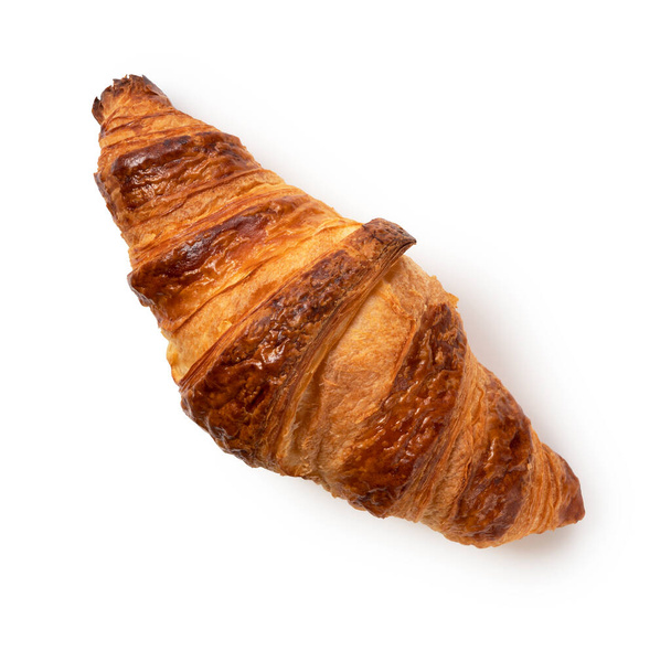 Jeden croissant umístěný na bílém pozadí. Pohled shora - Fotografie, Obrázek