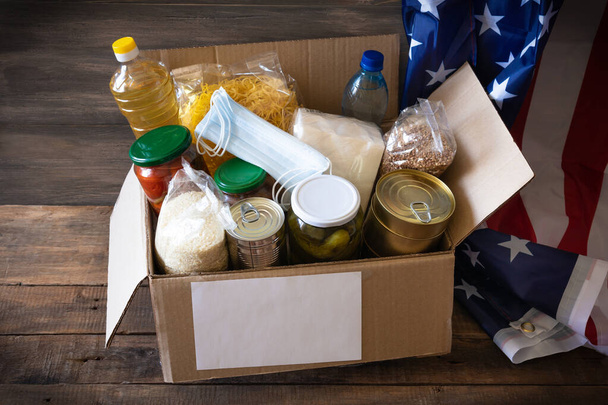 Box with food stock. Cardboard box with butter, canned food, cereals and pasta. Reserve. Donation. - Фото, изображение