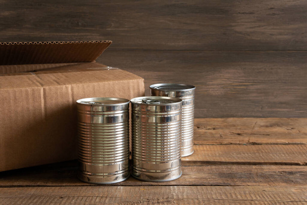 Canned food and food on a dark wooden background. Foodstock concept - Photo, Image