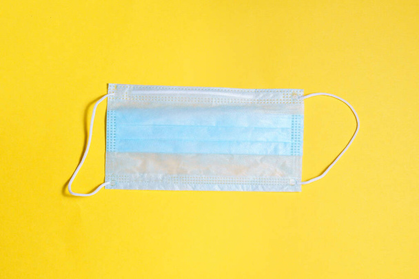 medical protective mask, on a yellow background Concept, fight, prevention, quarantine against coronavirus flu infection. Flat lay - Foto, immagini