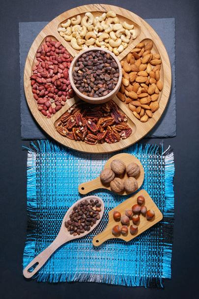 Assortment of nuts. Hazelnuts, walnuts, pecans, peanut, almond walnuts Food mix background top view - Photo, Image