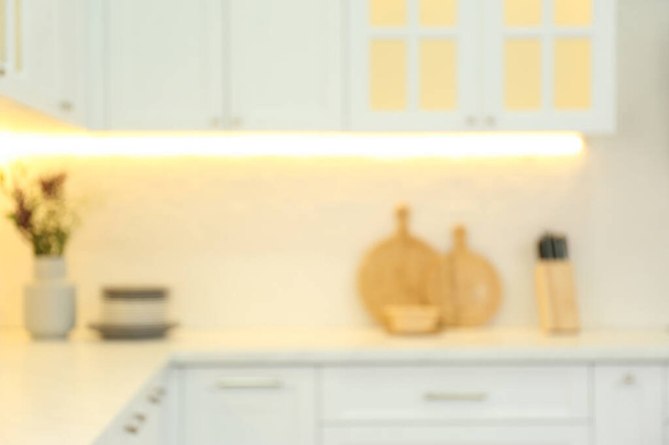 Blurred view of modern kitchen interior with stylish furniture - Фото, зображення