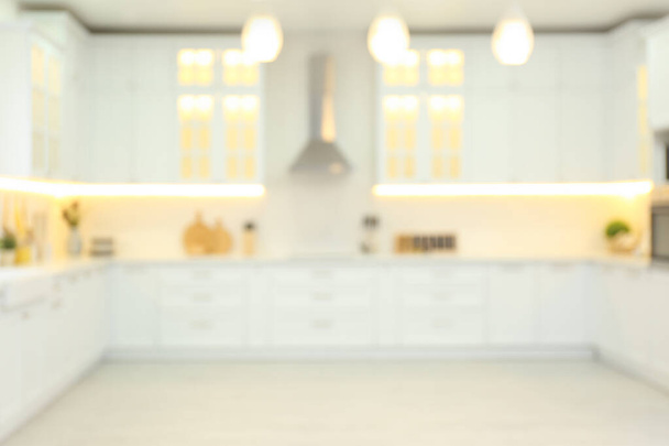 Blurred view of modern kitchen interior with stylish furniture - Photo, Image