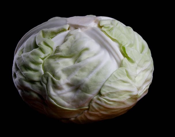 Fresh cabbage, isolated on a black background. - Фото, изображение