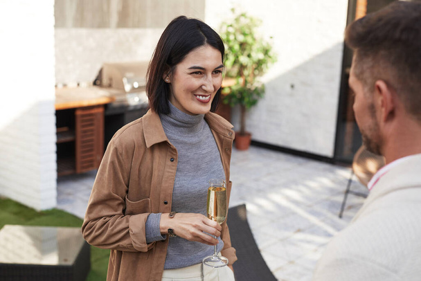Waist up portrait of elegant modern woman smiling happily while talking to friend at outdoor party, copy space - Foto, afbeelding