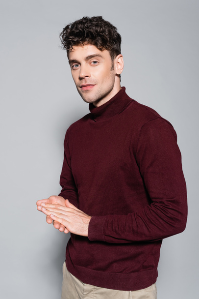 young man in burgundy jumper posing isolated on grey - Φωτογραφία, εικόνα