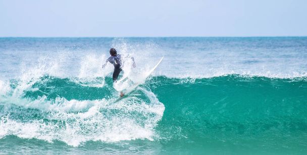 A professional surfer surfing on the waves - Foto, Imagem