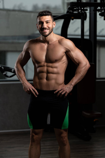 Portrait of a Young Physically Fit Man Showing His Well Trained Body - Muscular Athletic Bodybuilder Fitness Model Posing After Exercises - Fotó, kép