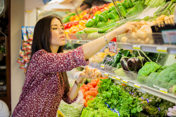 Cute brunette buying some groceries - Фото, зображення