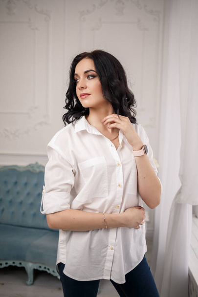 business portrait of a young female businessman. Dressed in a white shirt. Business style concept - Photo, image