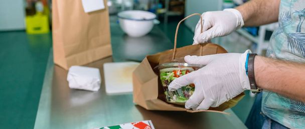 Unrecognizable cook packing a takeaway order - Photo, Image